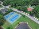 Two tennis courts situated near a pond and residential area at 28 Golf Villa Dr, Port Orange, FL 32128