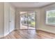 Bedroom with wood-look flooring and sliding glass doors leading to a screened porch at 28 Golf Villa Dr, Port Orange, FL 32128