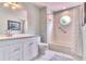Clean bathroom with white vanity, tub, and round window at 28 Golf Villa Dr, Port Orange, FL 32128