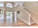 Spacious living room with high ceilings, wood-look flooring, and access to a patio at 28 Golf Villa Dr, Port Orange, FL 32128