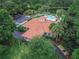 Community center with a tile roof, pool, and ample parking at 28 Golf Villa Dr, Port Orange, FL 32128