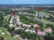 Aerial view of community near Airport Rd and a community pool at 28 Golf Villa Dr, Port Orange, FL 32128