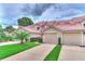 Tan two-story townhome with a red tile roof and a two-car garage at 28 Golf Villa Dr, Port Orange, FL 32128
