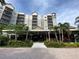 Multi-story building with outdoor patio and lush landscaping at 14501 Grove Resort Ave # 2740, Winter Garden, FL 34787