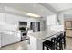 Kitchen features white cabinets, granite island, and stainless steel appliances at 4445 S Atlantic Ave # 606, Ponce Inlet, FL 32127