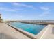 Community pool with ocean views and lounge chairs at 4445 S Atlantic Ave # 606, Ponce Inlet, FL 32127