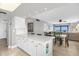 White kitchen cabinets, granite countertops, open to dining area at 4445 S Atlantic Ave # 606, Ponce Inlet, FL 32127