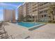 Community pool with surrounding lounge chairs at 4445 S Atlantic Ave # 606, Ponce Inlet, FL 32127