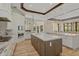 Bright kitchen featuring a large island, custom cabinetry, and top-of-the-line appliances at 11617 Waterstone Loop Dr, Windermere, FL 34786