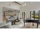 Open living room with kitchen views, hardwood floors, and a grand piano at 11617 Waterstone Loop Dr, Windermere, FL 34786