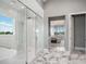 Spa-like bathroom with a large glass shower, soaking tub, and marble flooring at 4007 Grande Brick Loop # 13, Orlando, FL 32837