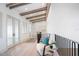 Light and airy hallway with hardwood floors and a comfortable seating area at 4139 Grande Brick Loop # 15, Orlando, FL 32837