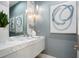 Elegant bathroom with marble vanity, modern fixtures, and artistic wall decor at 4139 Grande Brick Loop # 15, Orlando, FL 32837