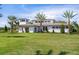 Exterior of community clubhouse with palm trees and manicured lawn at 4139 Grande Brick Loop # 15, Orlando, FL 32837