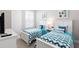 Cozy bedroom with twin beds, nightstands, and blue bedding at 7538 Sunville Ave, Kissimmee, FL 34747