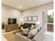 Cozy living room with a flat-screen TV, comfortable sofas, and ample natural light at 7538 Sunville Ave, Kissimmee, FL 34747