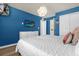 Bedroom with white bedding, TV, and en-suite bathroom access at 1909 Tropical Palms Cir, Kissimmee, FL 34747