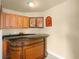 Home bar with dark countertop and wooden cabinetry at 6443 Cartmel Ln, Windermere, FL 34786
