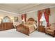 Spacious Primary bedroom with ornate bed and ample furniture at 6443 Cartmel Ln, Windermere, FL 34786