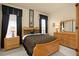 Guest bedroom with wood bed and matching furniture at 6443 Cartmel Ln, Windermere, FL 34786