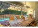 Covered patio overlooking pool and spa. Dining table with seating for eight at 6443 Cartmel Ln, Windermere, FL 34786
