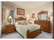 Bright bedroom with wood bed and leafy bedding at 6443 Cartmel Ln, Windermere, FL 34786
