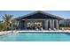 Community pool with covered patio and lounge chairs at 728 Costa Ln, Debary, FL 32713