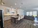 Modern kitchen with granite island and stainless steel appliances at 728 Costa Ln, Debary, FL 32713