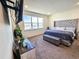 Main bedroom with a tufted headboard and large windows at 728 Costa Ln, Debary, FL 32713