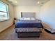 Main bedroom with a tufted headboard, bench, and carpet at 728 Costa Ln, Debary, FL 32713
