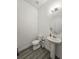 Powder room with pedestal sink, toilet and gray flooring at 728 Costa Ln, Debary, FL 32713