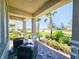Covered porch with stone columns, wicker furniture, and view of neighborhood at 728 Costa Ln, Debary, FL 32713