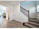 Bright entryway with wood-look floors and an elegant staircase at 728 Costa Ln, Debary, FL 32713