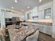 Modern kitchen with white cabinets, granite countertops, and stainless steel appliances at 728 Costa Ln, Debary, FL 32713