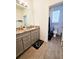 Double vanity bathroom with granite countertops, grey cabinets, and shower at 728 Costa Ln, Debary, FL 32713