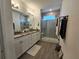 Bathroom with double vanity, granite countertop, and walk-in shower at 728 Costa Ln, Debary, FL 32713