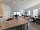 Granite kitchen island with sink, faucet, and breakfast bar at 728 Costa Ln, Debary, FL 32713