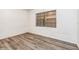 Simple bedroom with wood-look floors and window at 1624 Grand St, Orlando, FL 32805