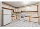 Kitchen with white appliances and wood cabinets at 1624 Grand St, Orlando, FL 32805