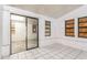 Sunroom with tiled floor, sliding glass door, and boarded windows at 1624 Grand St, Orlando, FL 32805