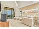 Bright living room featuring a sectional sofa and large windows at 3062 Rockefeller Way, Kissimmee, FL 34747