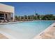 Resort-style pool with lounge chairs and water features at 3062 Rockefeller Way, Kissimmee, FL 34747