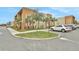 Townhome building with parking lot and surrounding landscape at 3062 Rockefeller Way, Kissimmee, FL 34747