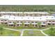 Complex of modern townhomes viewed from above, showing building layout and landscaping at 3062 Rockefeller Way, Kissimmee, FL 34747