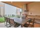 Outdoor kitchen area with built-in grill, granite countertop, and dining table at 3062 Rockefeller Way, Kissimmee, FL 34747