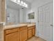 Bathroom with double vanity and light wood cabinets at 902 Towhee Ct, Celebration, FL 34747