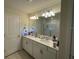 Double vanity bathroom with a large mirror and a walk-in shower at 14563 Orchid Island Dr, Orlando, FL 32827