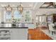 Large kitchen with an island, white cabinets, and a view into the living room at 5507 Worsham Court, Windermere, FL 34786
