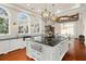 Modern kitchen with white cabinets, black countertops, and large island at 5507 Worsham Court, Windermere, FL 34786
