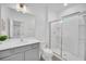 Modern bathroom with gray vanity, white countertop, and glass shower at 6115 High Seas Dr, Orlando, FL 32821
